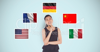 Thoughtful businesswoman standing by various flags against blue background