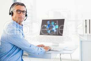Business man working on his computer and wearing Headset