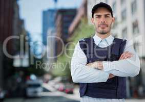 Security guard with arms folded against blurry street