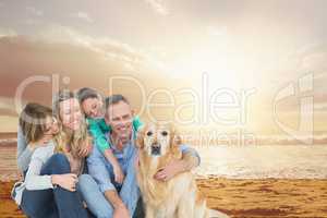 Smiling family with a dog on the beach