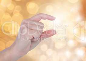 Hand gesturing small with sparkling light bokeh background