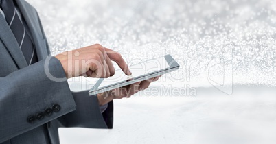 Businessman holding tablet with bright sparkling star spangled background