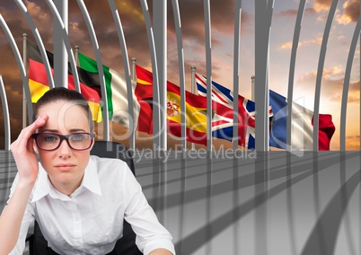 main language flags behind the window. Young bored woman in the office