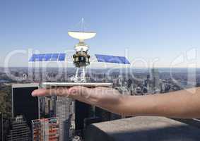 solar panel satellite  on hand with city behind