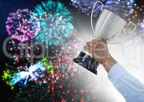 business hand with trophy, colors fireworks and white flare behind the hand