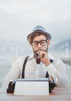 Hipster man  on typewriter with foggy mountain landscape