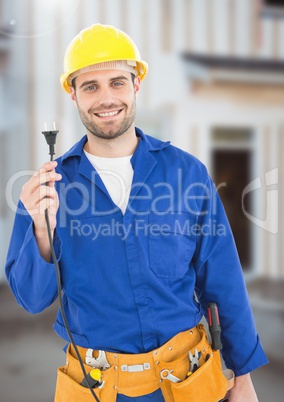 Electrician with wires cables on building site