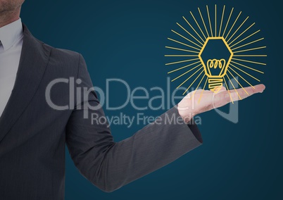 Business man mid section with yellow lightbulb graphic in hand against blue background