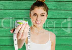 fitness woman apple and meter with green wood background