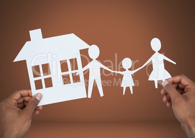 Cut outs of house and  family in hands