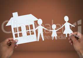 Cut outs of house and  family in hands