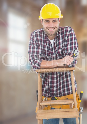 Construction Worker on ladder in front of construction site