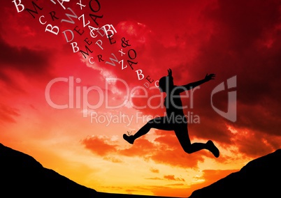 woman jumping in the mountain silhouette with text coming up from her head. Red and orange sunset