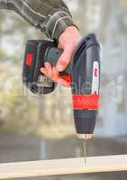 Hand with drill on building site