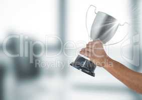 Hand holding trophy against defocused background