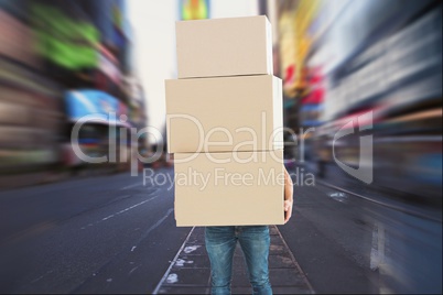Deliver is holding packages against cityscape background