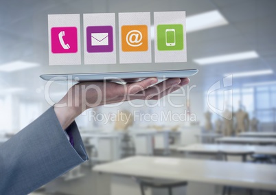 Businesswoman holding tablet with apps icons in workshop factory