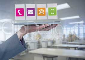 Businesswoman holding tablet with apps icons in workshop factory