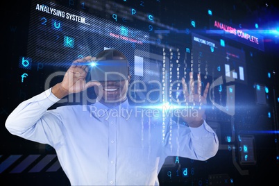 Businessman wearing a virtual reality headset against matrix background