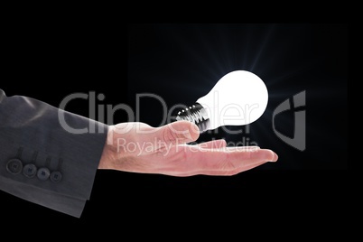 bulb on hands against black background