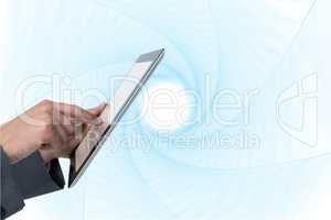 Finger touching tablet computer screen against abstract background