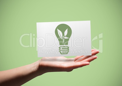Hand with card showing green lightbulb graphic against green background