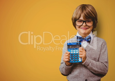 Boy smiling with calculator against yellow background