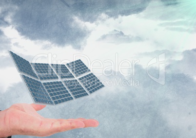 Cropped image of hand with solar panel against cloudy sky