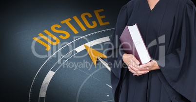 Midsection of judge holding book against justice clock