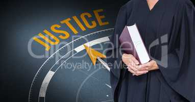 Midsection of judge holding book against justice clock