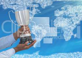 Digital image of hands holding trophy against world map