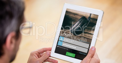Man holding digital tablet with login text