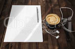 Letterhead, coffee, headphones, pen
