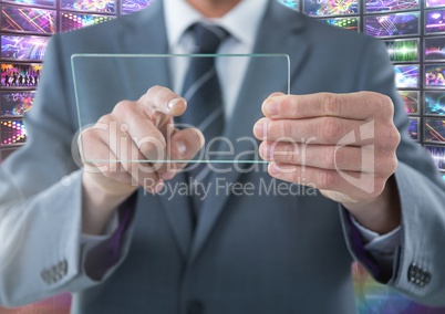 Businessman holding glass screen with colorful screens visuals