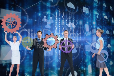 Businessmen and business women are holding sprocket against graphics background