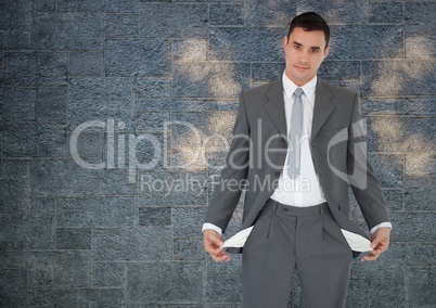 empty pockets businessman with rock wall background