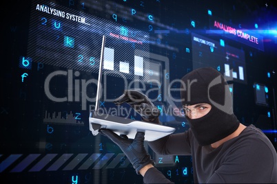 Cyber criminal holding a laptop and wearing a hood against matrix background