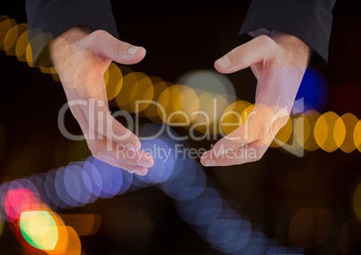 Hands holding invisible space with sparkling light bokeh background