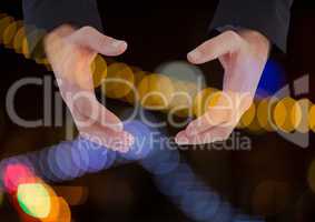 Hands holding invisible space with sparkling light bokeh background