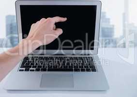 Businessman touching laptop by window