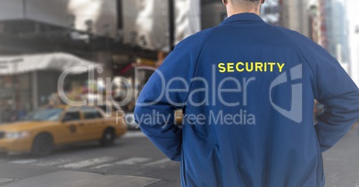 Back of security guard against blurry street