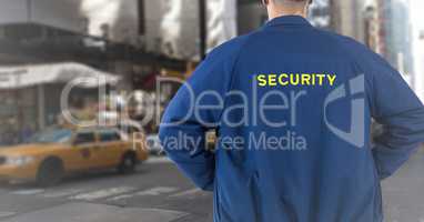 Back of security guard against blurry street