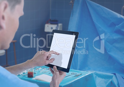 Doctor holding tablet in surgery room