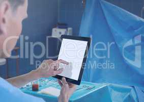 Doctor holding tablet in surgery room