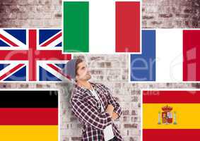 main language flags around young man. Brick wall background