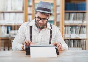 Hipster man  on typewriter in library