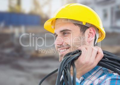 Electrician with wires cables on building site