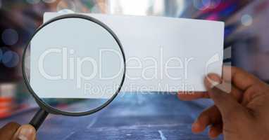 magnifying glass looking at paper on street