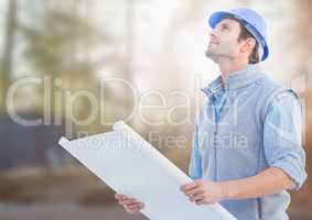 Architect with blueprints on building site