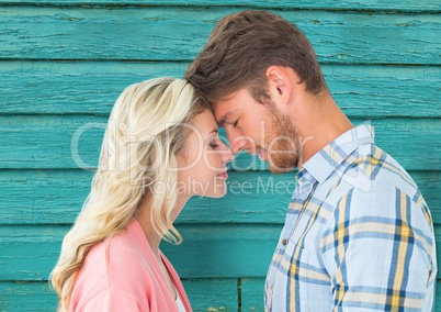 young happy couple with light blue wood background